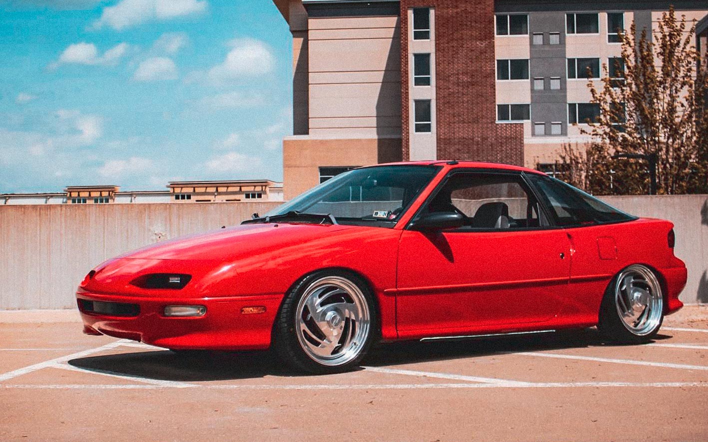 red 1993 Geo Storm