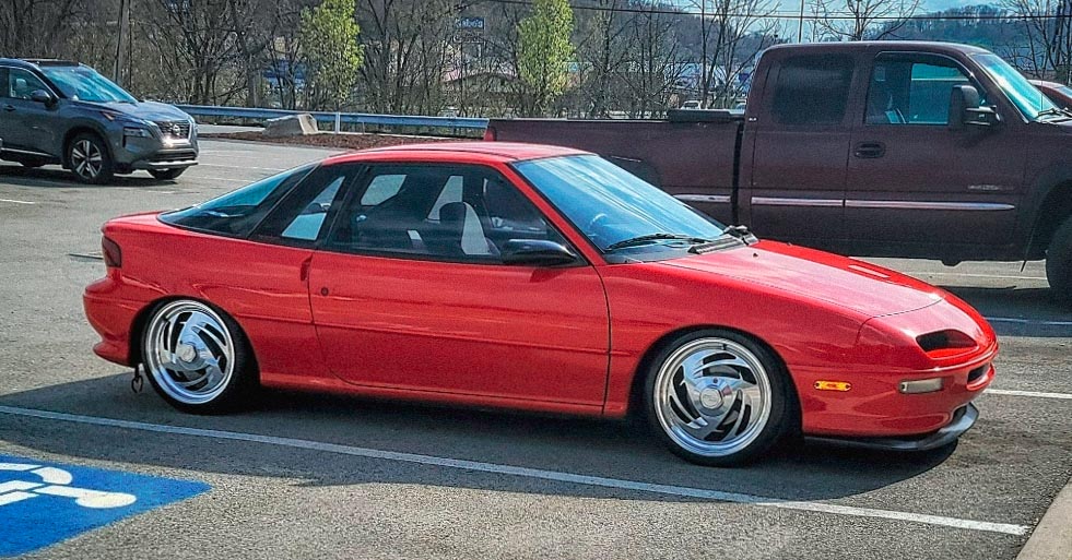 red 1993 Geo Storm