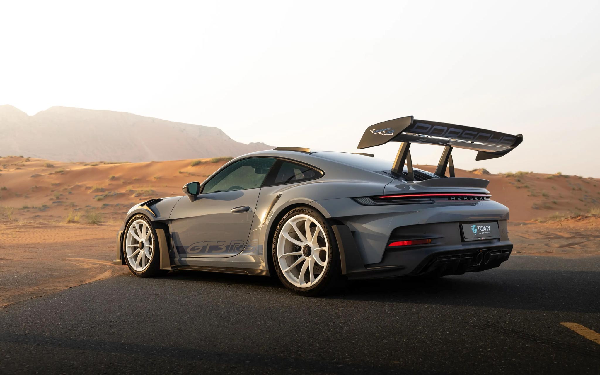 gray Porsche GT3 RS in desert of UAE