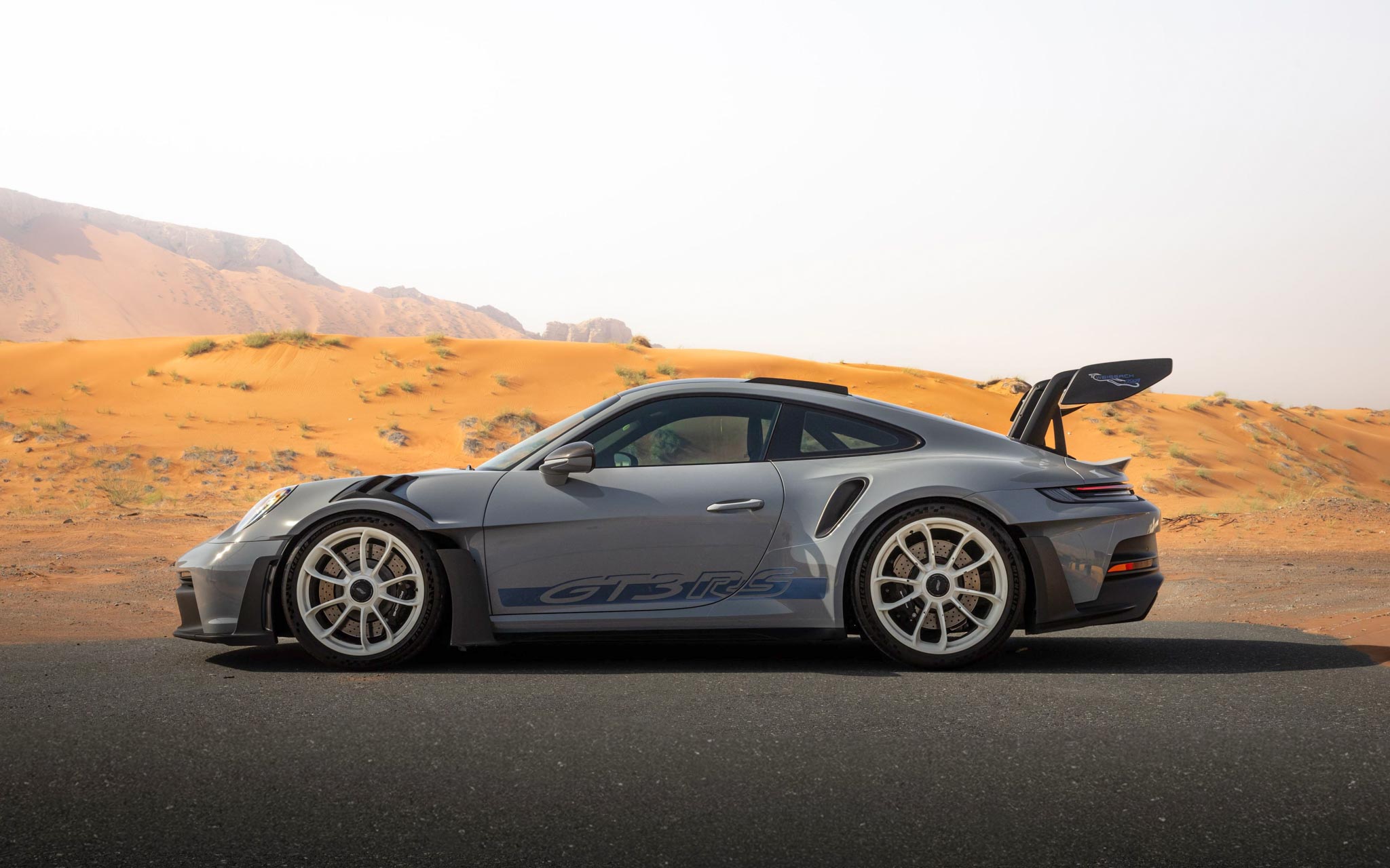gray Porsche GT3 RS in desert of UAE