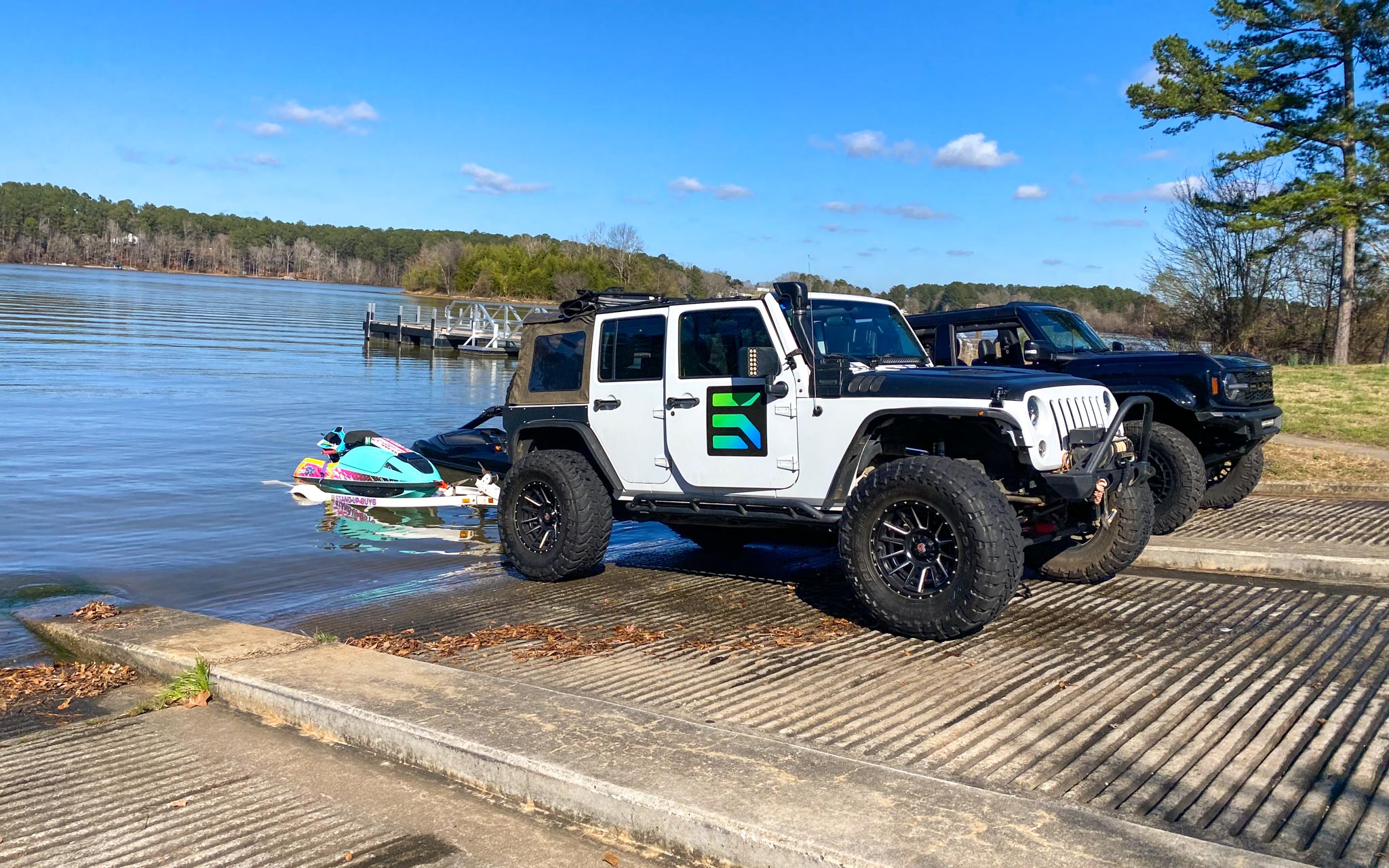 Jeep at the lake towing jet ski