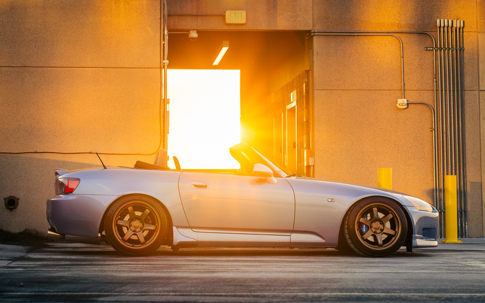 lowered Honda S2000 at golden hour sunset